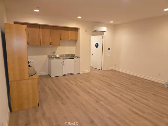 a kitchen with stainless steel appliances a refrigerator sink and cabinets