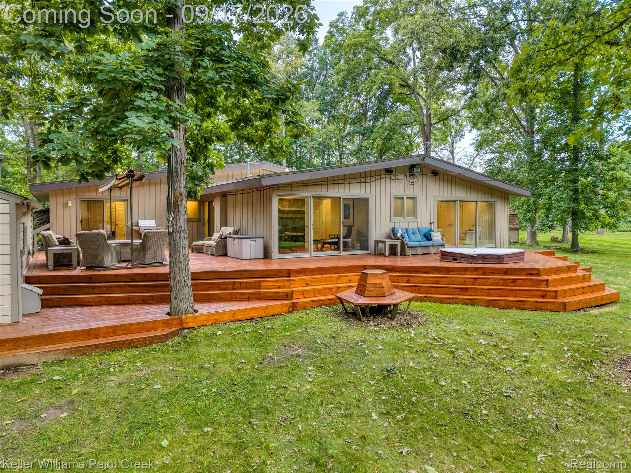 4535 Orion Road Rochester, MI 48306 - Photo 16 of 67 Expansive terraced wood deck with multi-level steps, integrated spa, and sliding glass doors