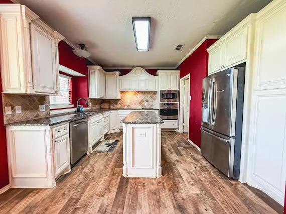a view of a kitchen with wooden floor and cabinet