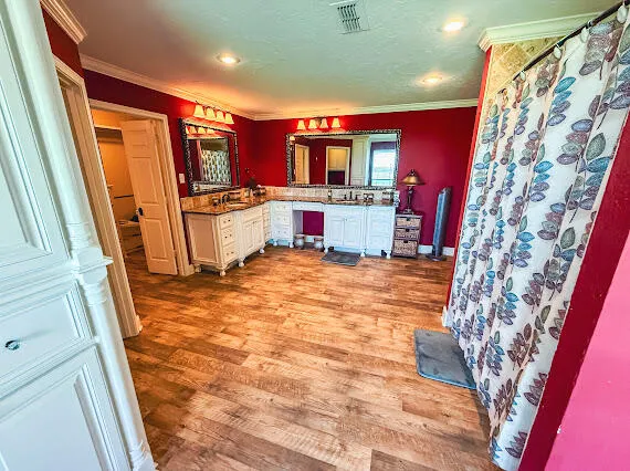 a workspace with furniture hardwood floor and windows