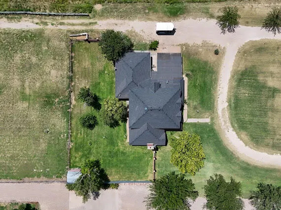 an aerial view of a house with outdoor space and lake view