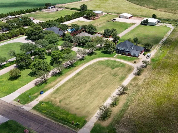 an aerial view of a residential houses with outdoor space