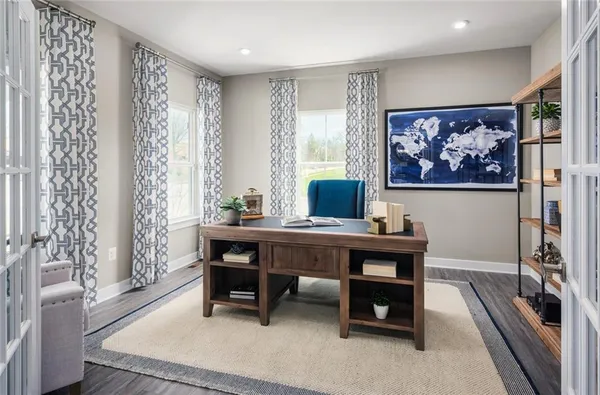 a view of a workspace with furniture and a window