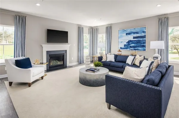 a living room with furniture and a fireplace