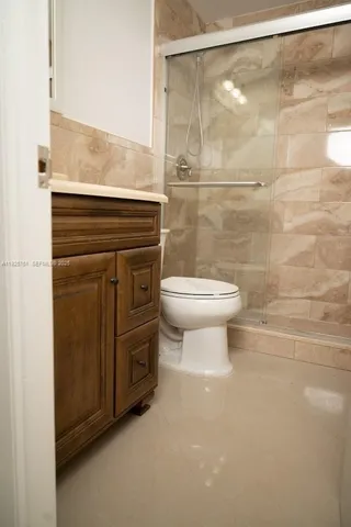 a bathroom with a toilet a sink and shower