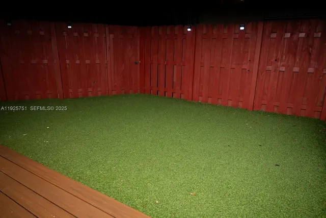 a view of an empty room with a wooden fence