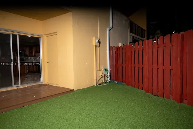 a view of an empty room with a wooden door
