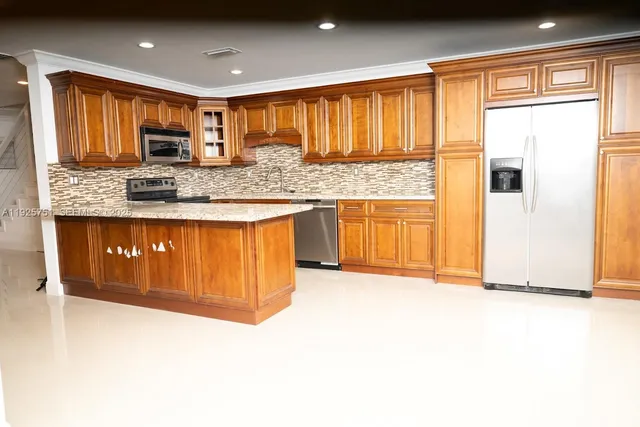 a kitchen with granite countertop sink stove and refrigerator