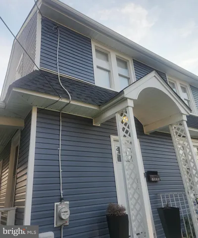 a front view of a house with wooden stairs