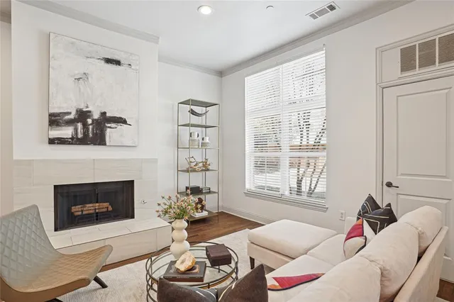 a living room with furniture a fireplace and a window