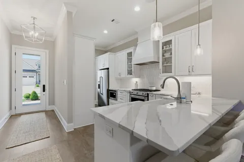 a kitchen with kitchen island a sink appliances and cabinets