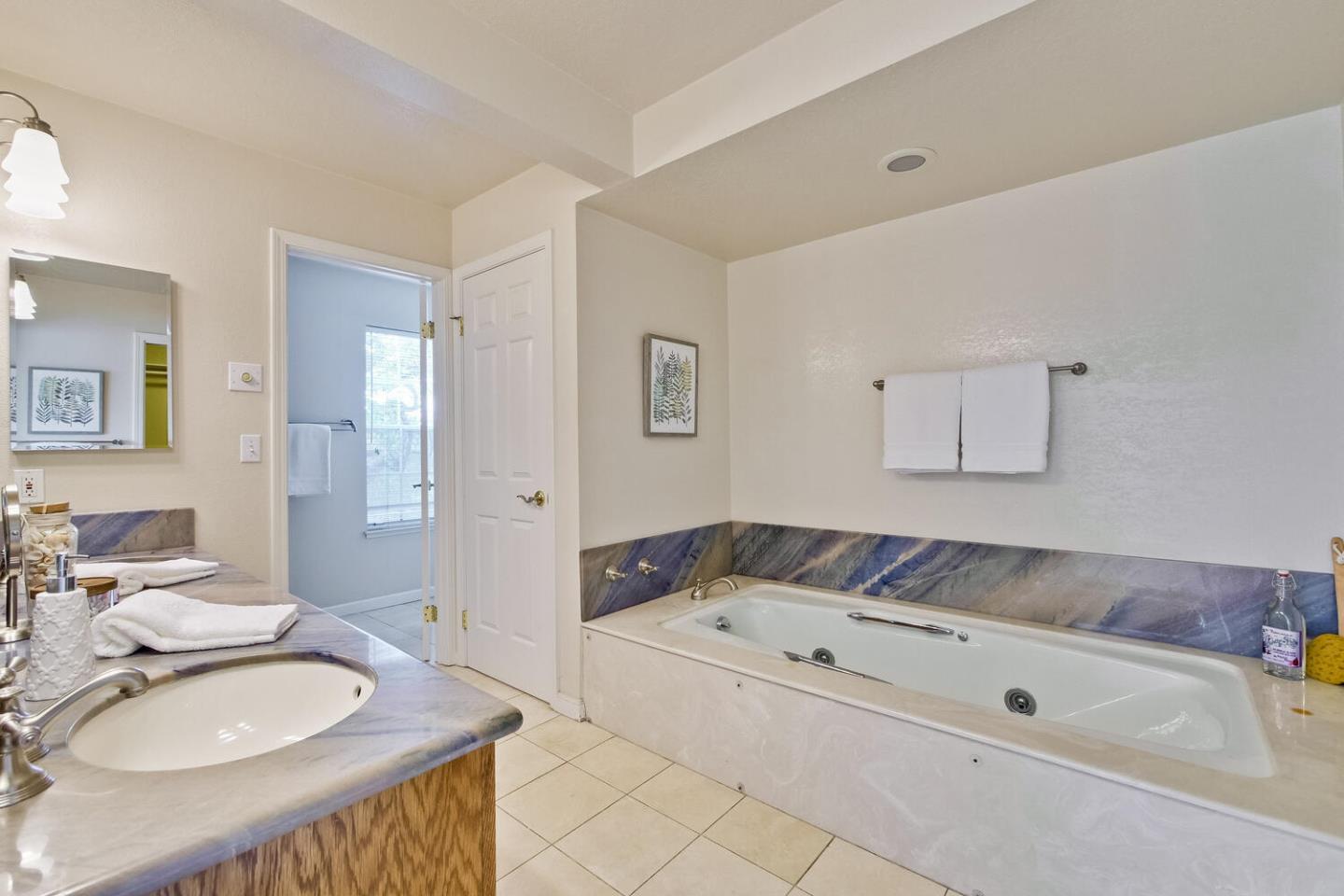 44 Holmes Drive San Jose, CA 95127 - Photo 30 of 48 a spacious bathroom with a granite countertop sink and a mirror