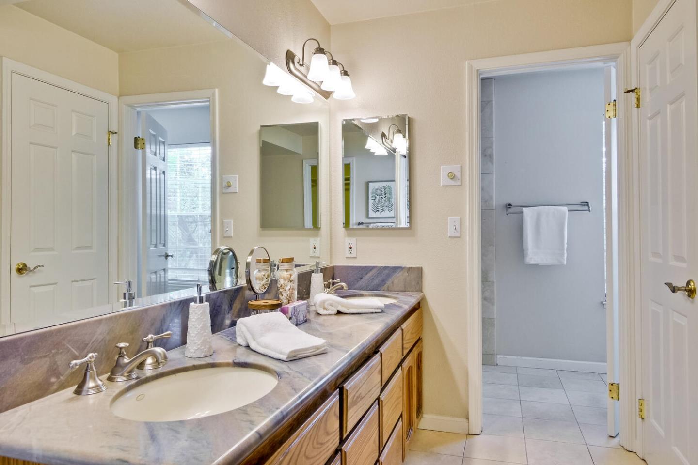 44 Holmes Drive San Jose, CA 95127 - Photo 33 of 48 a bathroom with a sink double vanity granite and a mirror