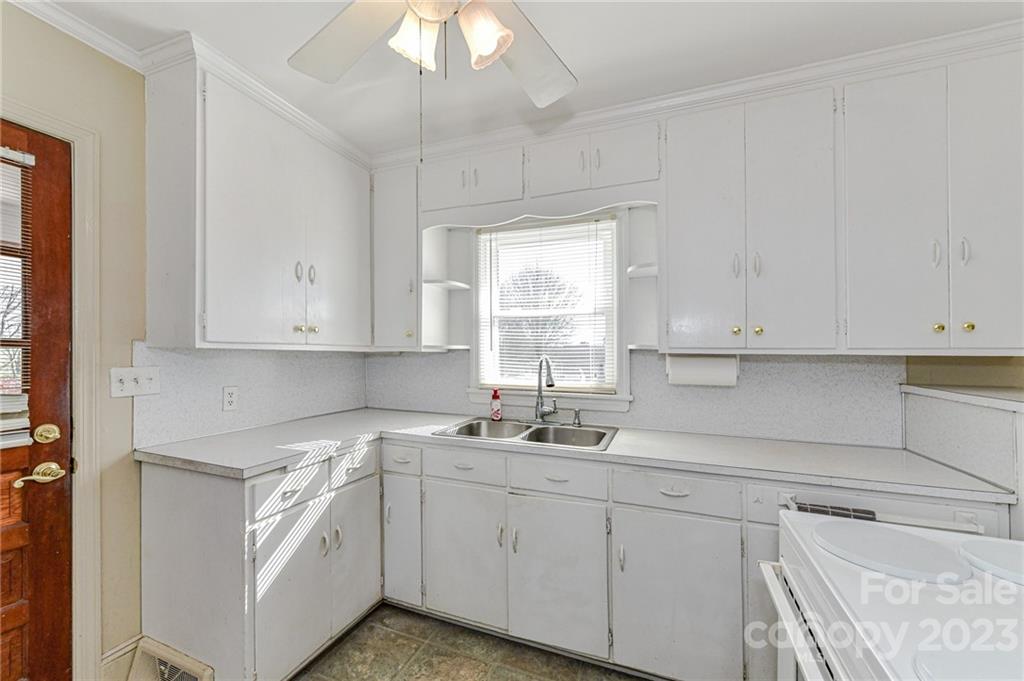 10008 Landsford Road Monroe, NC 28112 - Photo 11 of 32 a kitchen with cabinets appliances a sink and a window