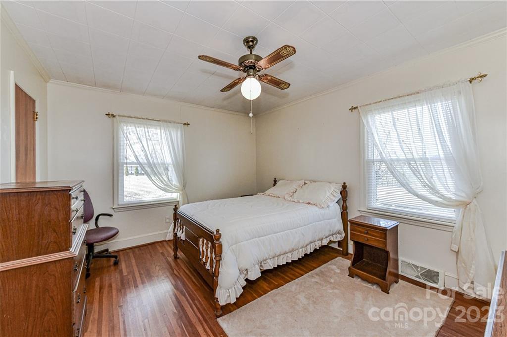10008 Landsford Road Monroe, NC 28112 - Photo 15 of 32 a bedroom with a bed and a chandelier