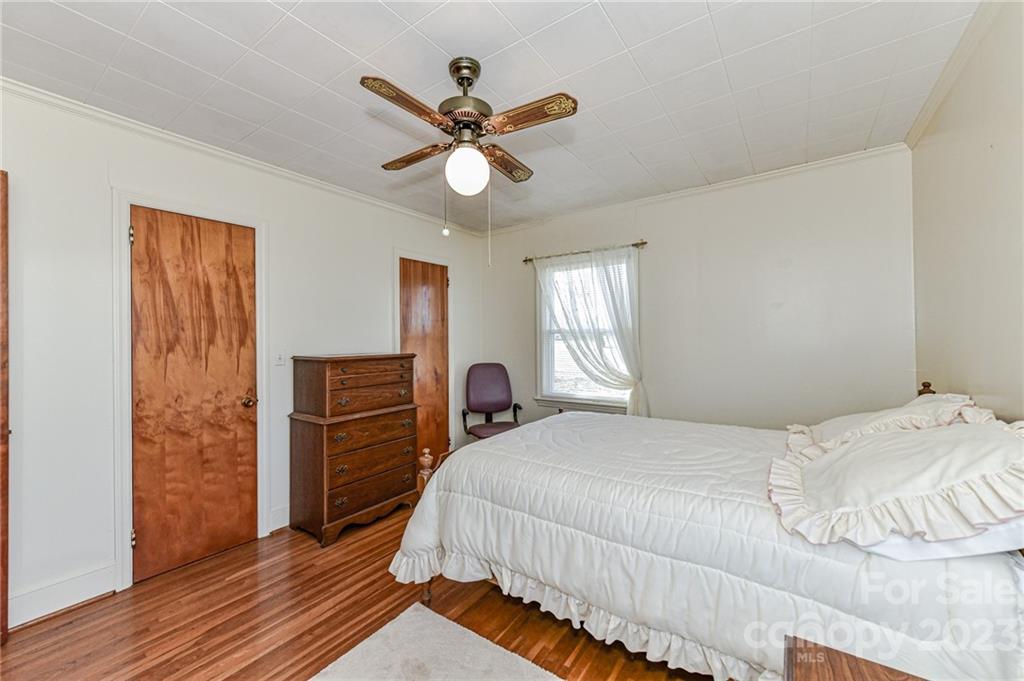10008 Landsford Road Monroe, NC 28112 - Photo 16 of 32 a bedroom with a bed and a chandelier