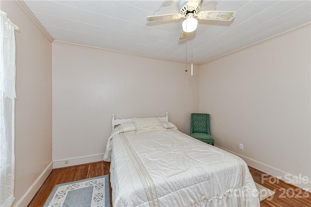 10008 Landsford Road Monroe, NC 28112 - Photo 19 of 32 a bedroom with a bed and a chandelier