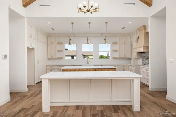 a large kitchen with kitchen island a stove a sink and a refrigerator