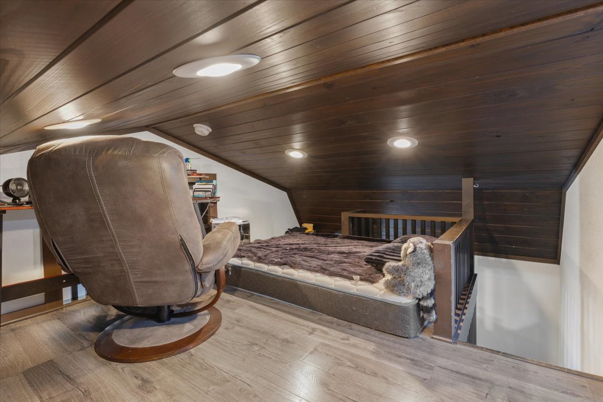 1705 Makinson Road West Point, TX 78963 - Photo 19 of 40 Experience cozy comfort in this loft bedroom featuring wood paneling and recessed lighting.