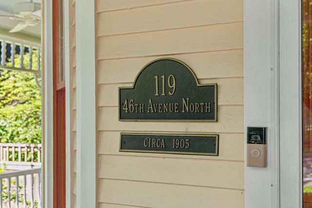 a living room with furniture a clock and a fireplace