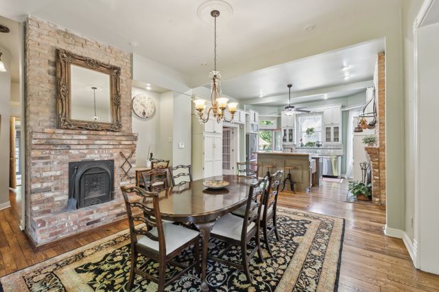 a living room with furniture a rug and a bookshelf