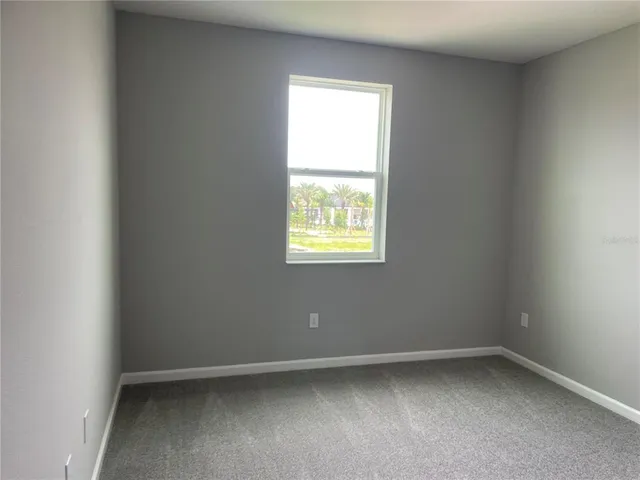 an empty room with a empty space and windows