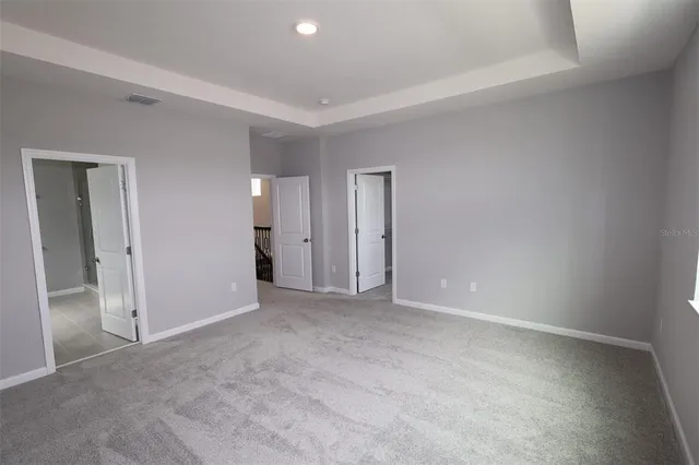 a view of a yard with wooden fence