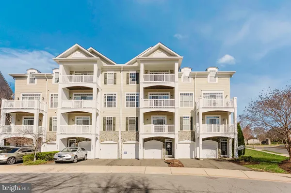 a front view of a residential apartment building with a yard