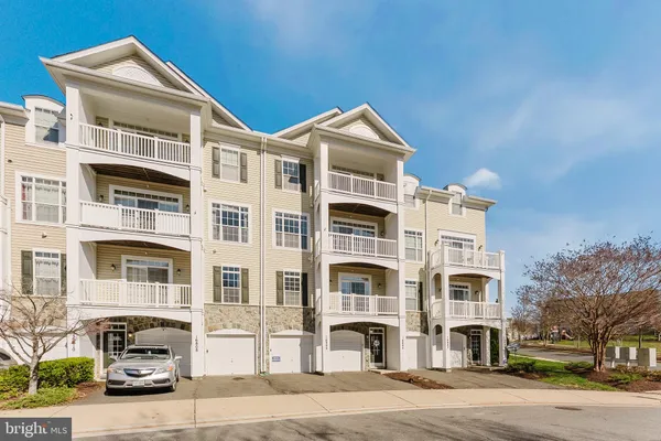 a front view of a residential apartment building with a yard