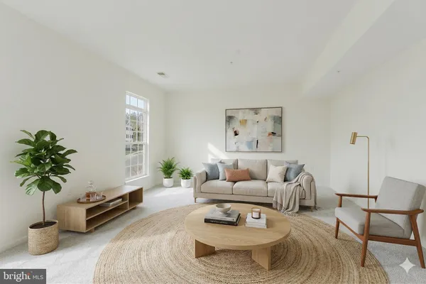 a living room with furniture potted plant and a window