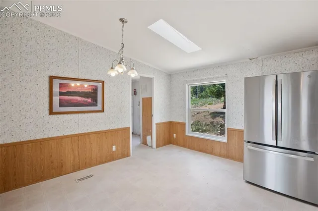 a kitchen with stainless steel appliances granite countertop a refrigerator a stove a microwave and cabinets