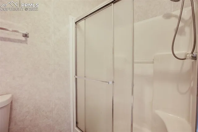 a bathroom with a glass shower door