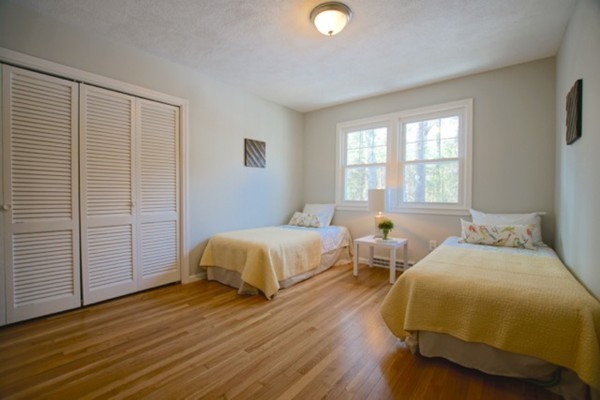 82 Herrick Road Boxford, MA 01921 - Photo 16 of 25 a spacious bedroom with two beds and wooden floor