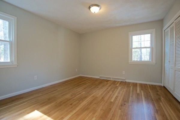 82 Herrick Road Boxford, MA 01921 - Photo 18 of 25 an empty room with wooden floor and windows
