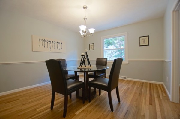 82 Herrick Road Boxford, MA 01921 - Photo 9 of 25 a view of a dining room with furniture a chandelier and wooden floor