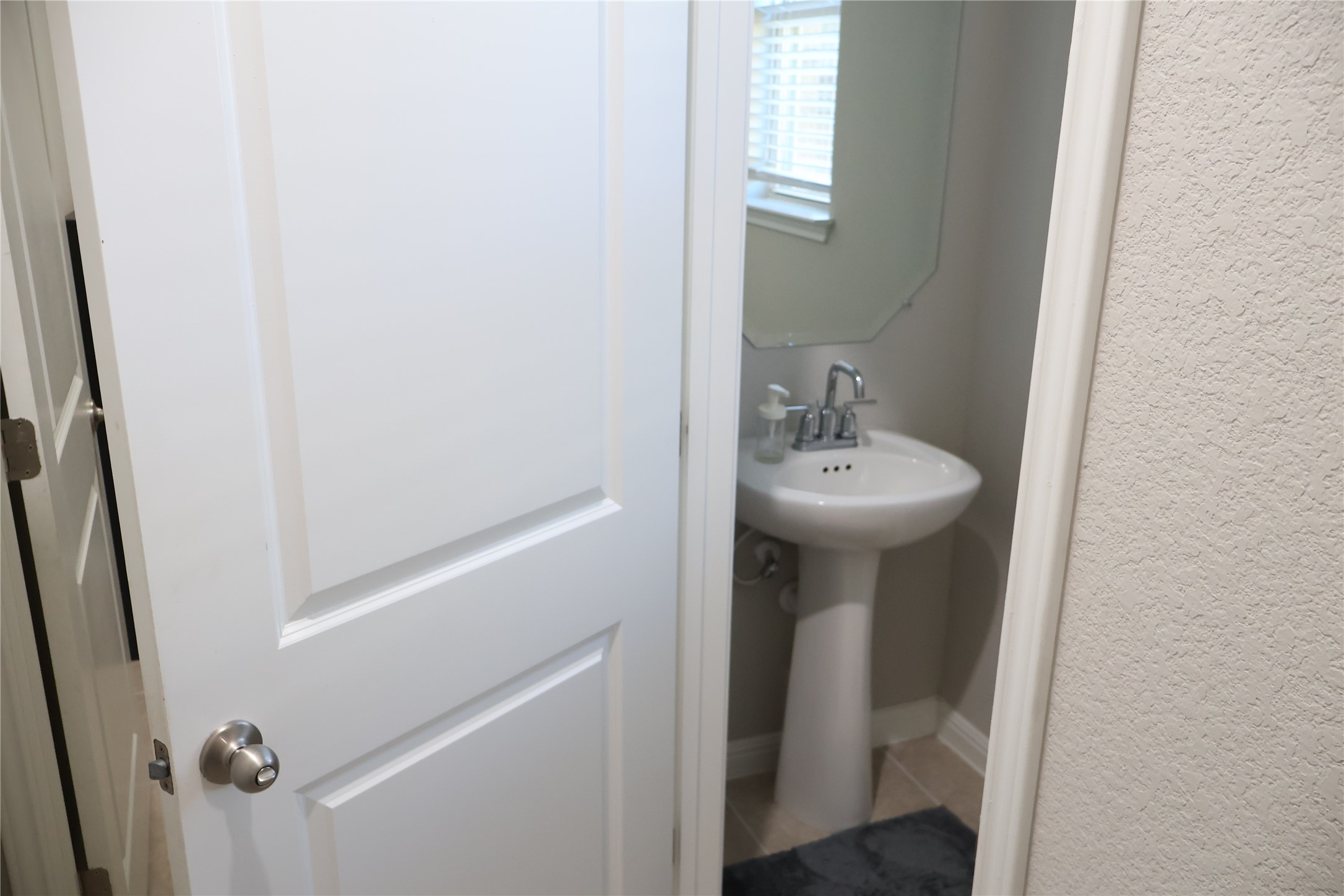 11500 Maple Leaf Way Manor, TX 78653 - Photo 11 of 29 Bathroom with light tile patterned floors and a textured wall