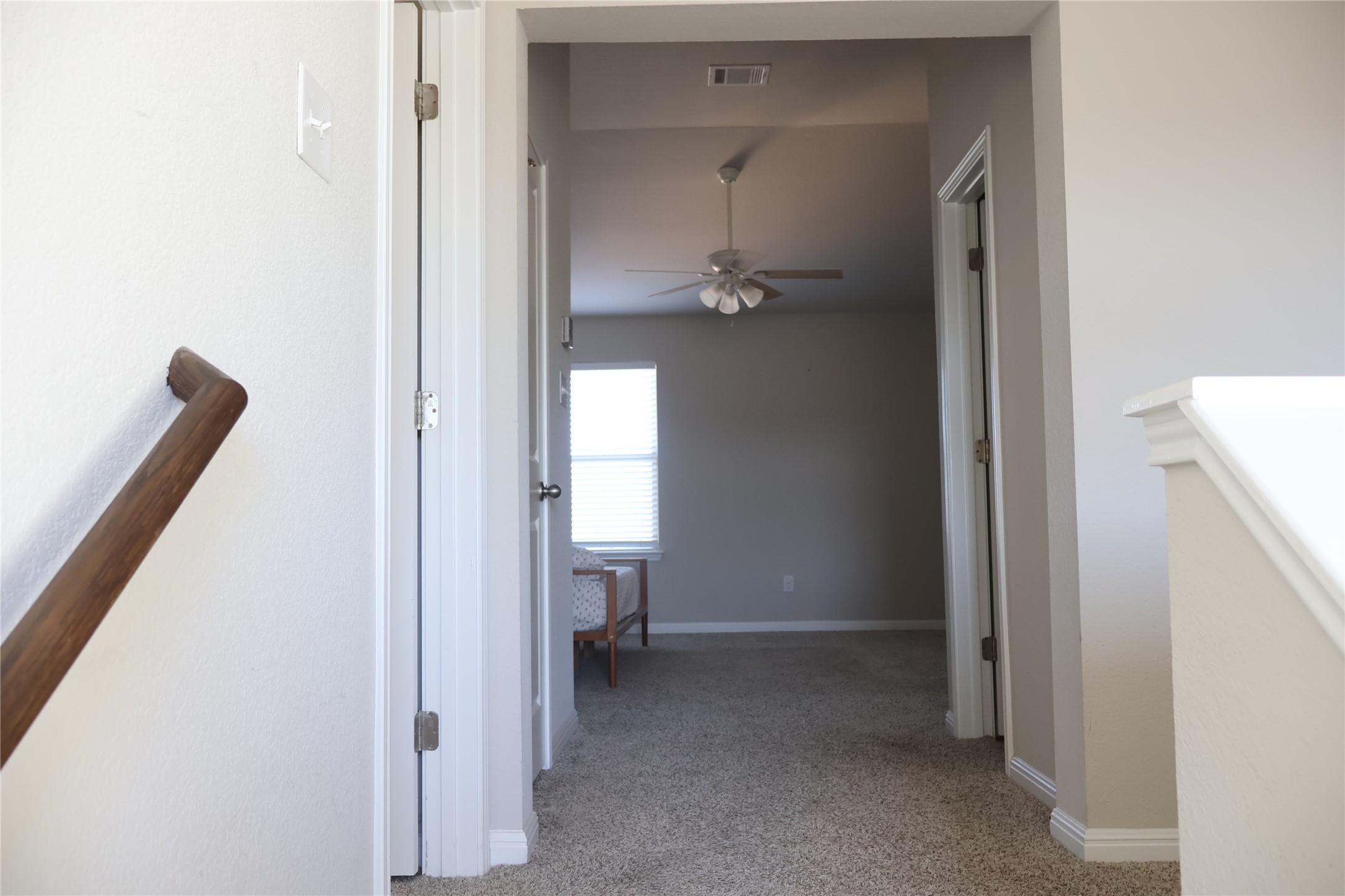 11500 Maple Leaf Way Manor, TX 78653 - Photo 13 of 29 Corridor with light carpet and baseboards
