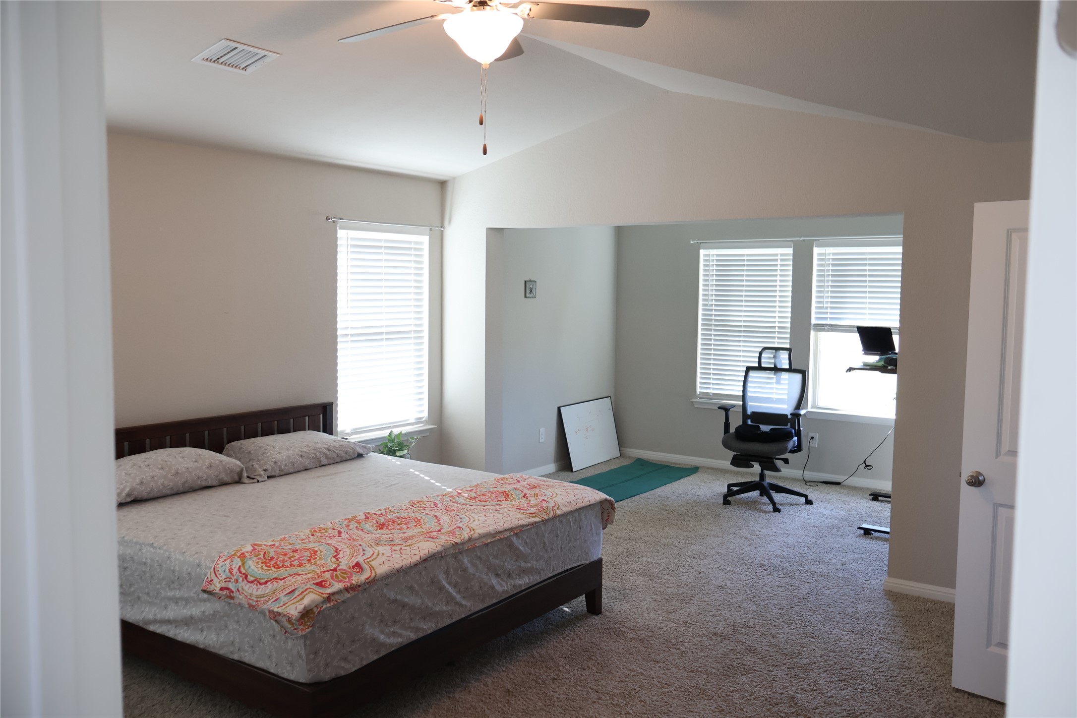 11500 Maple Leaf Way Manor, TX 78653 - Photo 14 of 29 Carpeted bedroom with ceiling fan, vaulted ceiling, and multiple windows