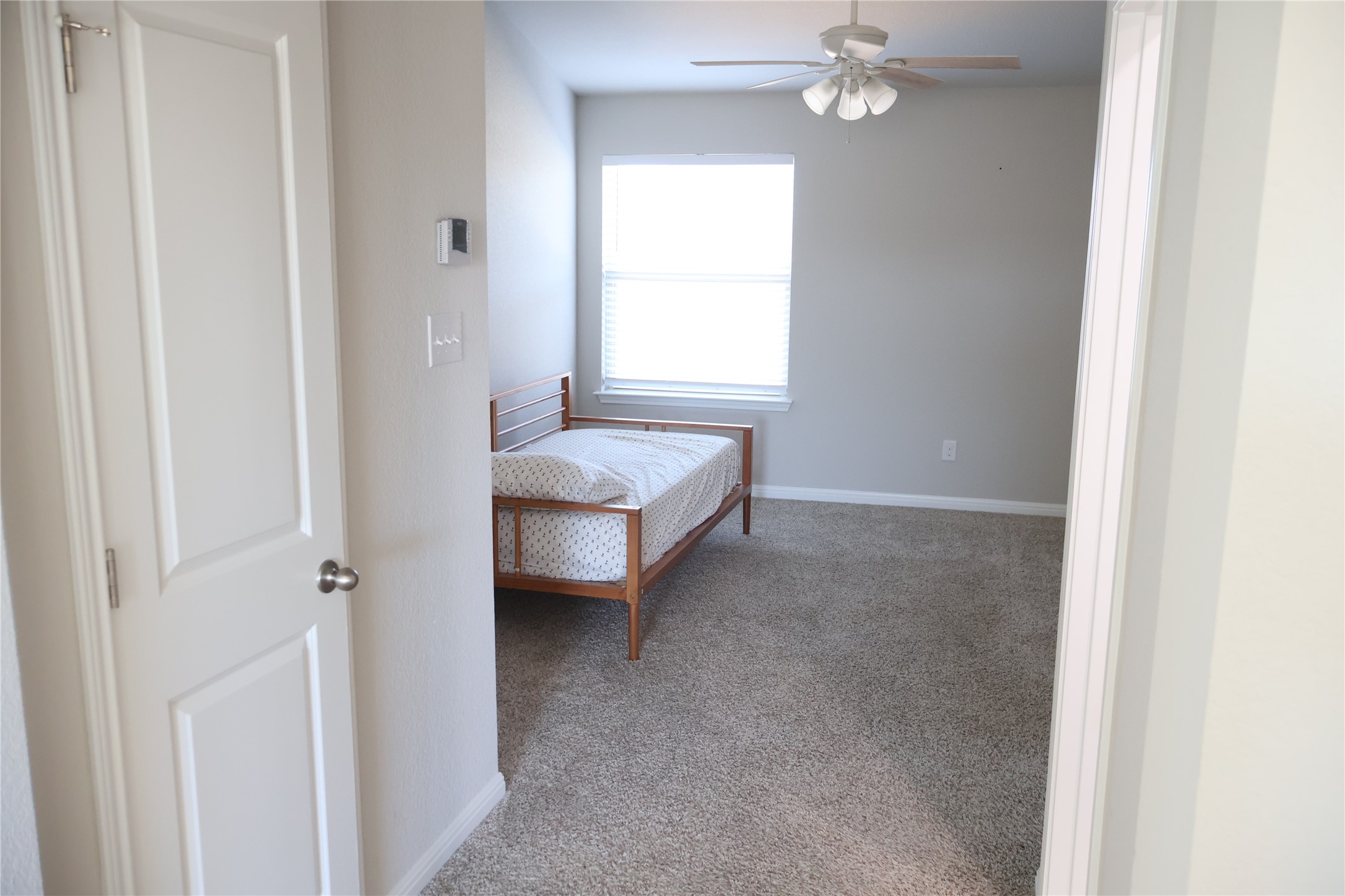 11500 Maple Leaf Way Manor, TX 78653 - Photo 24 of 29 Bedroom with light colored carpet and a ceiling fan