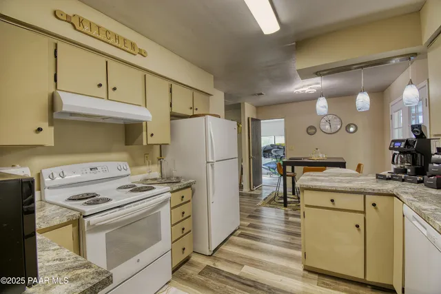 a kitchen with a stove a refrigerator and a sink