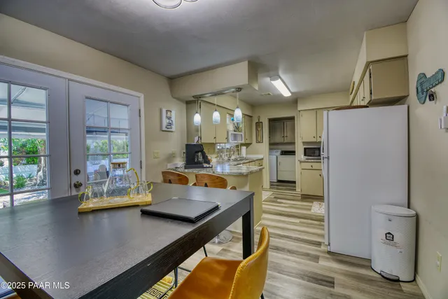 a view of a kitchen with dining table and chairs