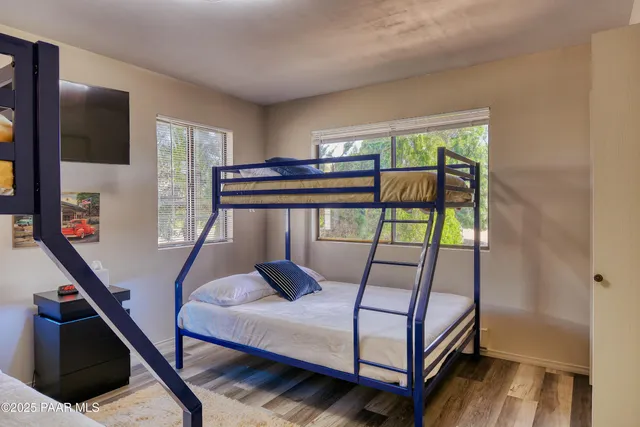 a bedroom with furniture window and wooden floor