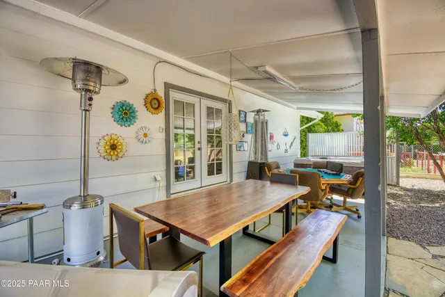 a living room with a table and a potted plant