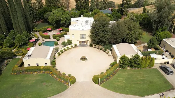 an aerial view of a house with outdoor space