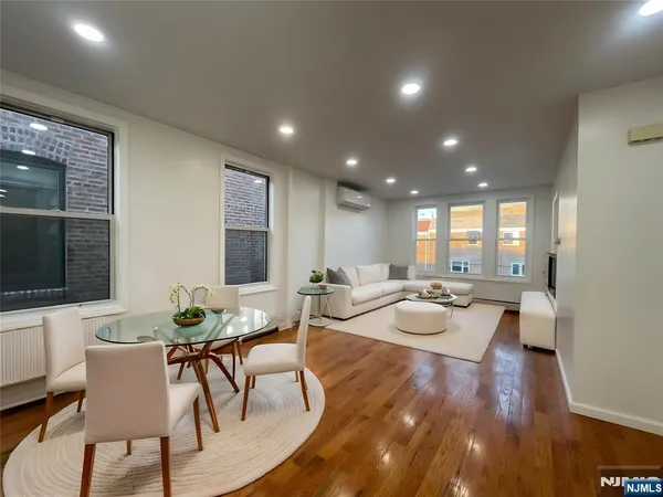 a view of a dining room with furniture window and wooden floor