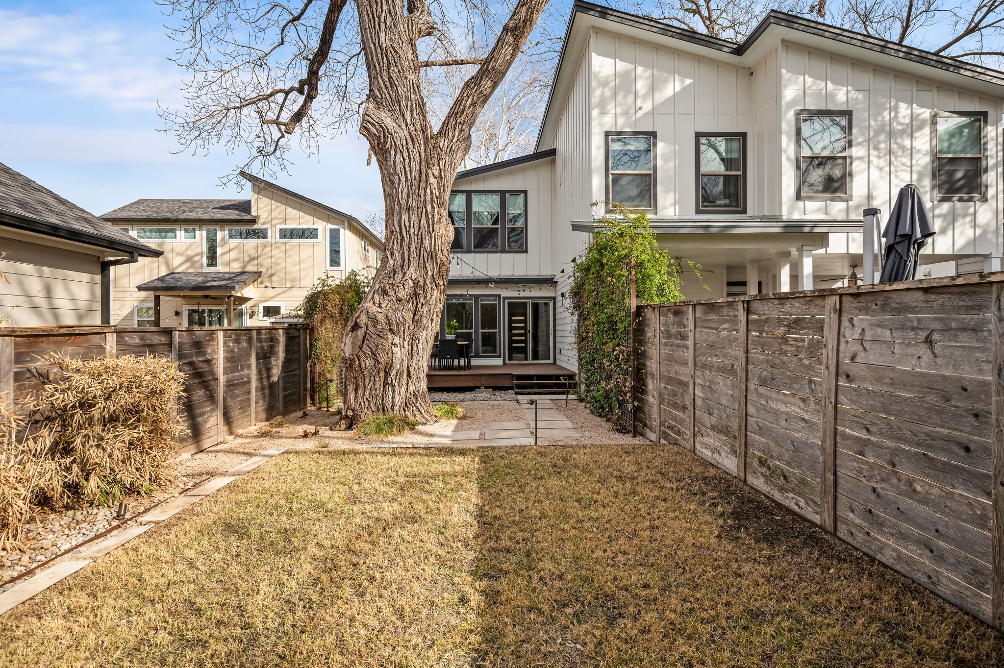 1124 Linden Street, Unit B Austin, TX 78702 - Photo 20 of 26 Back of house with a wooden deck, a fenced backyard, and board and batten siding