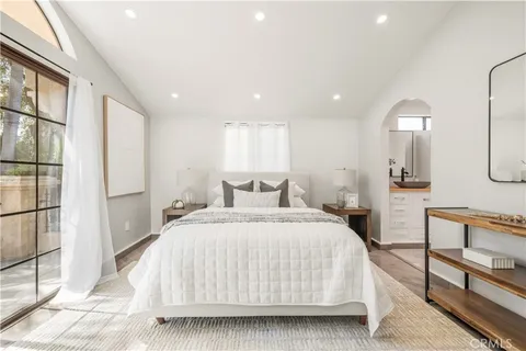 a bedroom with bed and a painting on the wall