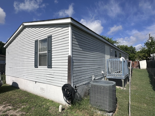 106 Ramirez Street Kyle, TX 78640 - Photo 4 of 19 A well-maintained single-story residence with a practical side deck and fence.