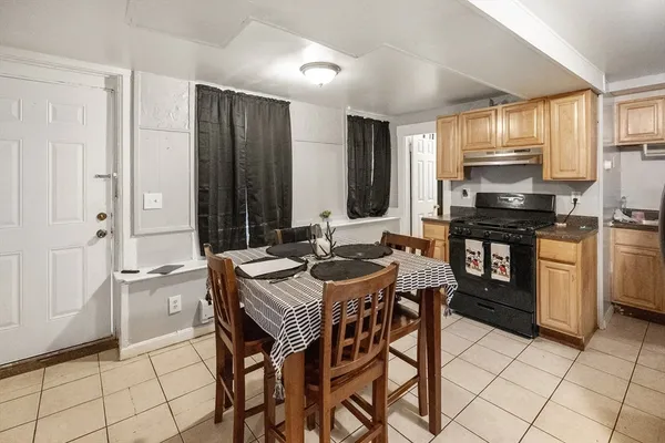 a kitchen that has a table and chairs in it