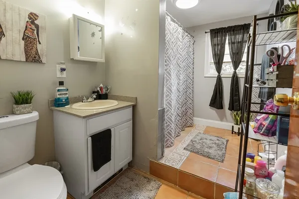 a bathroom with a sink toilet and shower